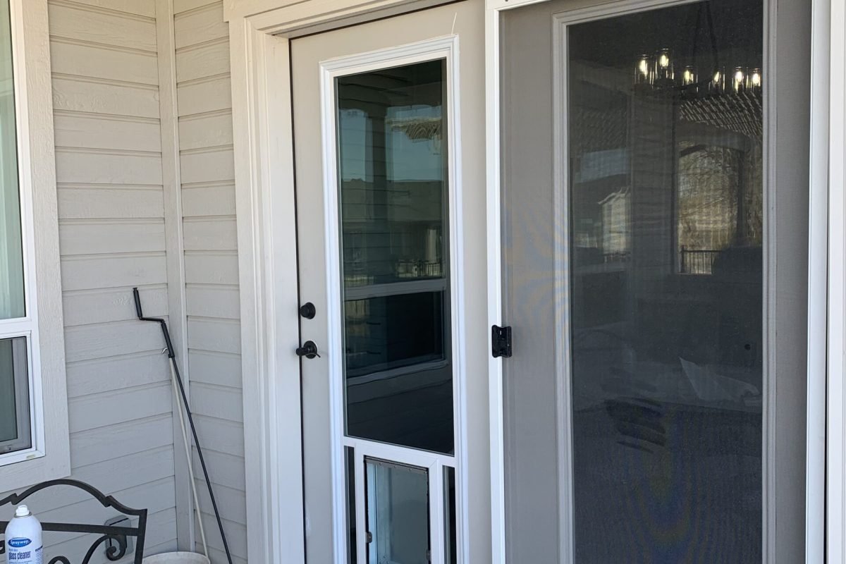 Atrium door with pet door in glass